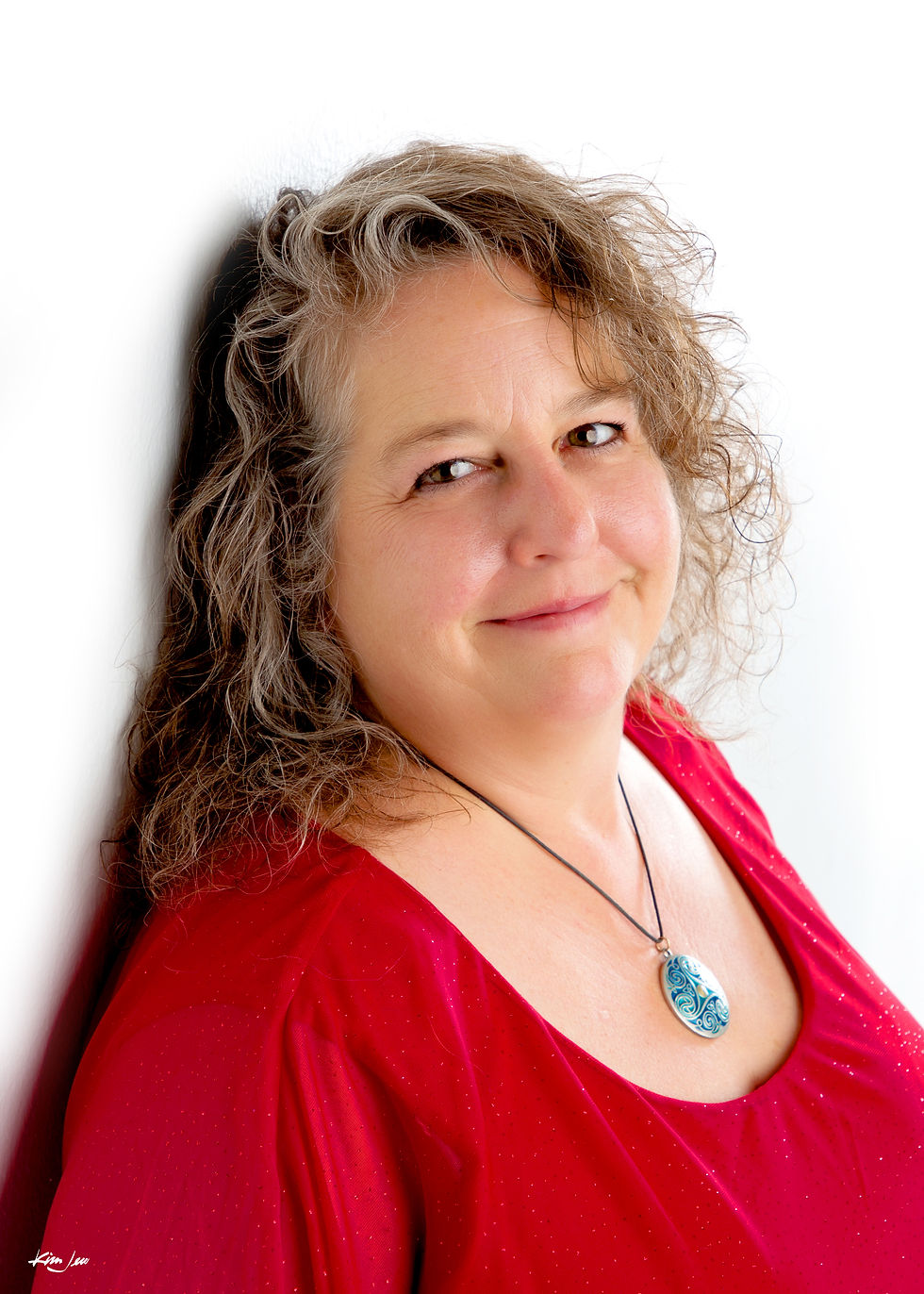 Stephanie in a red shirt against a white background