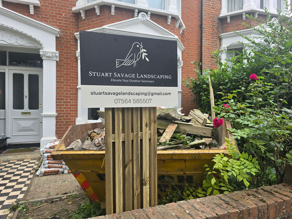 Stuart Savage Landscaping sign next to a skip during a Dulwich, South London garden renovation project