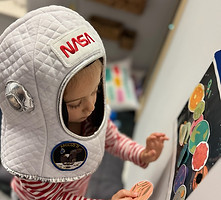 Move and Bloom Therapy Girl Wearing Nasa Astronaut Helmet