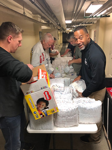 volunteers pack diapers