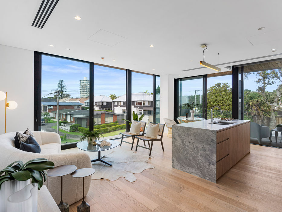 Luxury living room with large windows, modern furniture and city view.