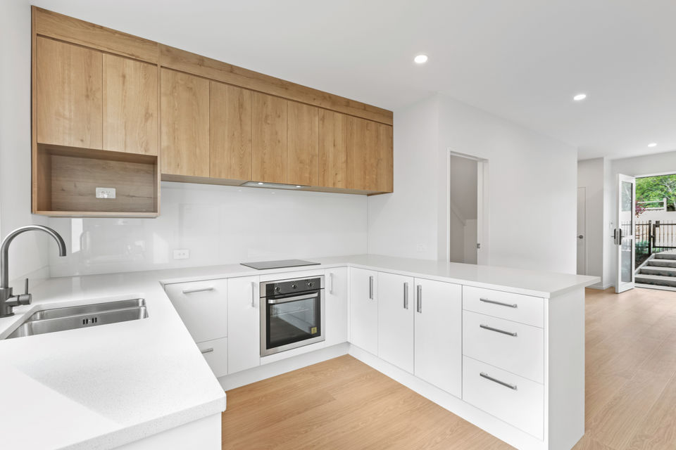 Modern kitchen design with wooden cabinets and white countertops
