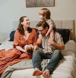 Family of 4 smiling at each other