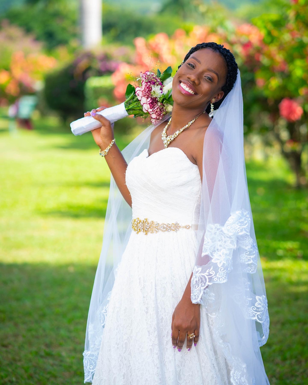 a beautiful Jamaican bride smiles for a photo