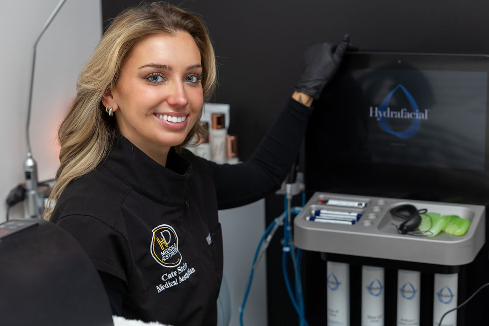 aesthetician sitting next to a HydraFacial machine