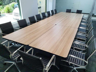 2. Alter Image Constructions - Soft padded Eames replica chairs surround mobile folding tables making up one larger meeting table