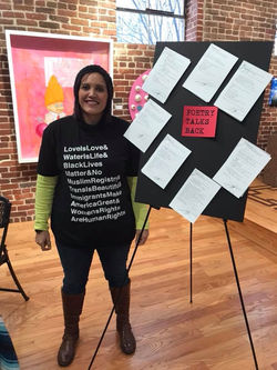Kai Coggin stands in front of her poems that she created during the POETRY TALKS BACK event.