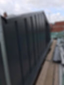 Work in progress view of installation of color coat cladding at stockport apartment conversion