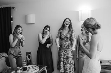 Bridesmaids surrounding the bride crying and laughing in Luxembourg