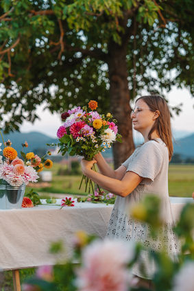 Florist holding colorful bouquet outdoors, personal brand photography Luxembourg floral designer