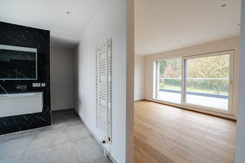 Empty bright room with large window and wooden floor, property photography Luxembourg interior