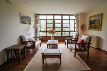 A chill-out area on the first-floor landing of a rural hotel in Luxembourg, furnished with couches, a sofa, and a table.