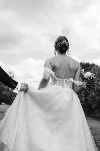 Bride walking away with dress flowing, artistic wedding photography Luxembourg