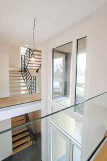 Modern hallway with glass floor and natural light, architectural interior photography Luxembourg
