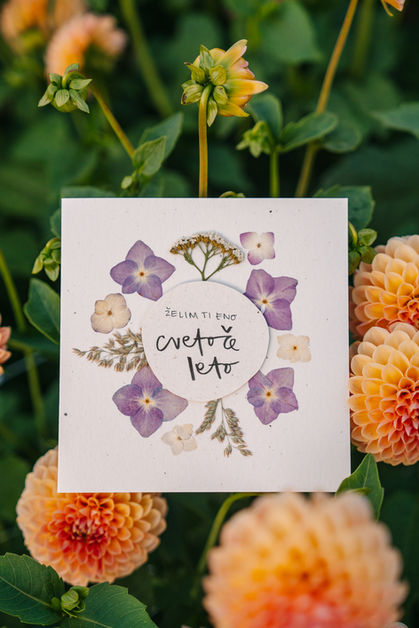 Close-up of handmade floral card surrounded by flowers, product photography Luxembourg artisan