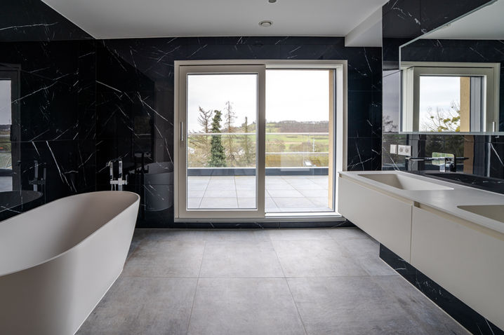 Luxury bathroom with freestanding bathtub and terrace view, interior photography Luxembourg modern property