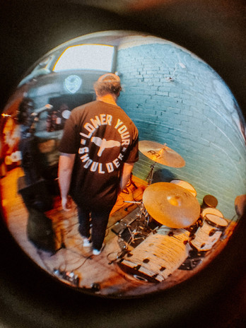 Jake walking onto soundcheck with his Black Hammer Series T-shirt