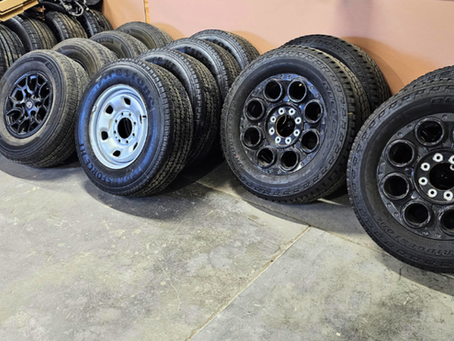Affordable recycled wheels lined up in a warehouse at Rubicon Automotive Group ready for replacement use
