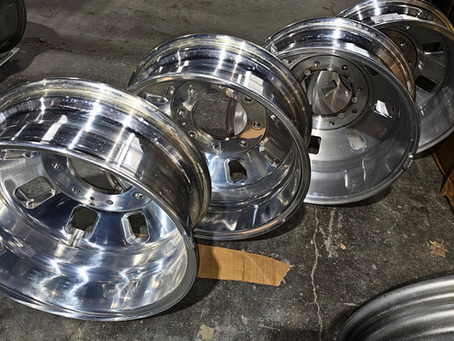 Polished recycled OEM truck wheels ready for resale at Rubicon Automotive Group warehouse inventory facility.