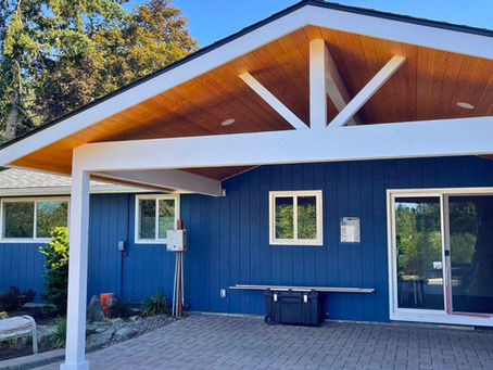 Custom patio cover installation for an Oregon homeowner featuring exposed wood accents and modern outdoor living design.