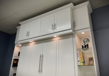 Two tone Murphy bed with upper bookcase showing the large upper bookcase doors closed.