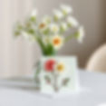 create a beautiful handcrafted card with flowers on the front sitting on a table with soft
