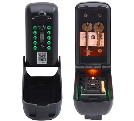 A modern black key lock box with illuminated green push-button keypad on the left unit and an open view on the right unit showing two stored keys inside, with internal lighting and secure mounting.
