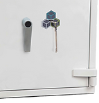 A close-up view of a white safe door featuring a handle and a key inserted into the lock, with a colorful cube logo displayed above the keyhole.