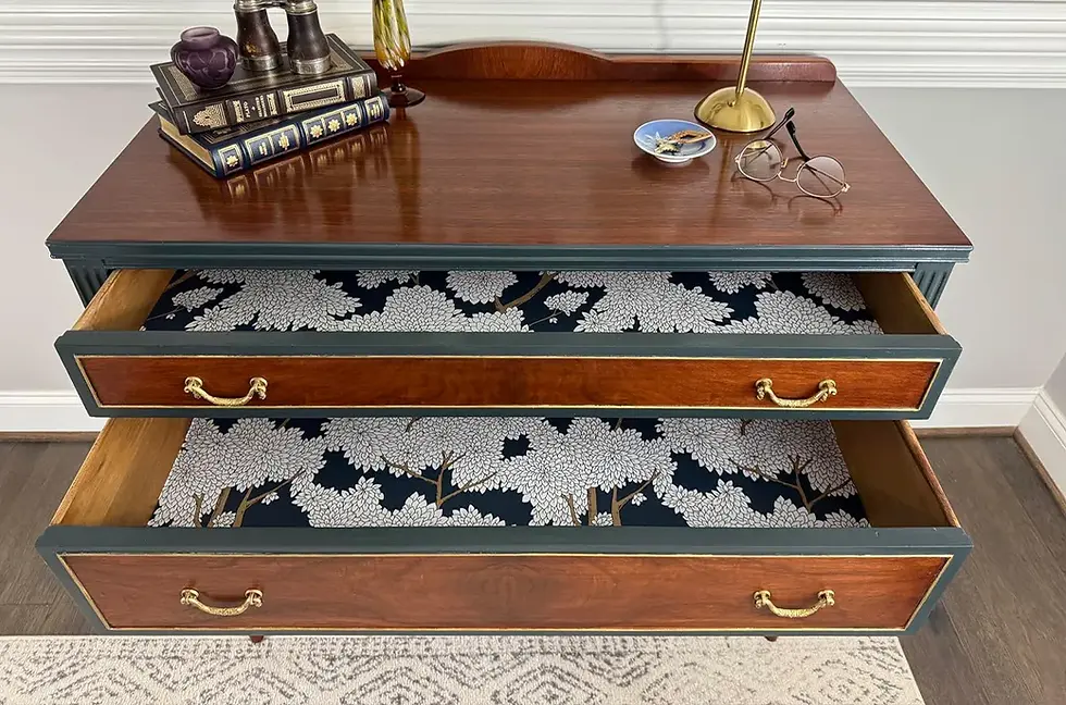 Removable wallpaper scraps repurposed as drawer liners in a vintage wooden dresser, adding a stylish and cohesive interior accent.