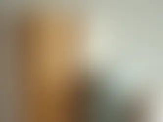 Designer reviewing custom wallpaper samples with a manufacturer's creative team in a modern studio.