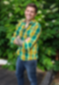 photo of Jimmy Czywczynski smiling in front of greenery