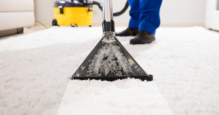 Close-up Of A Janitor Cleaning Carpet With Vacuum Cleaner At Home.jpg
