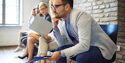 People in a lobby waiting for an interview.
