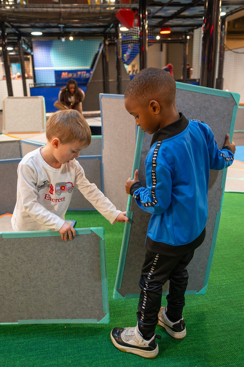 Two boys building with Montessori materials