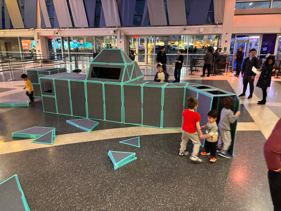uperspace transforms public spaces into hands-on play environments - kids collaboratively build and explore a large-scale felt panel structure at a museum or science center exhibit.