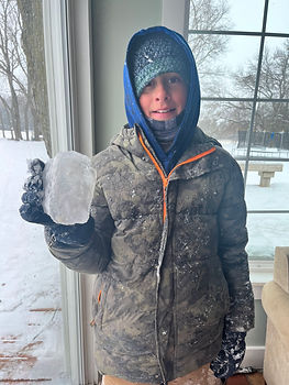Boy holding ice from frozen pond