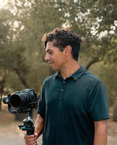 picture of saman dadafshar, wedding photographer and videographer holding his equipment