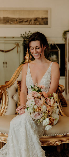 Bride portrait sitting with her bouquet 