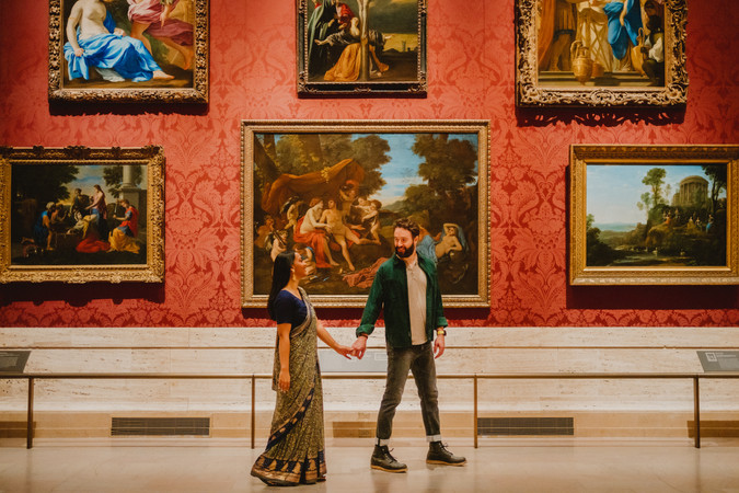 man and woman holding hands and walking through art gallery in Boston
