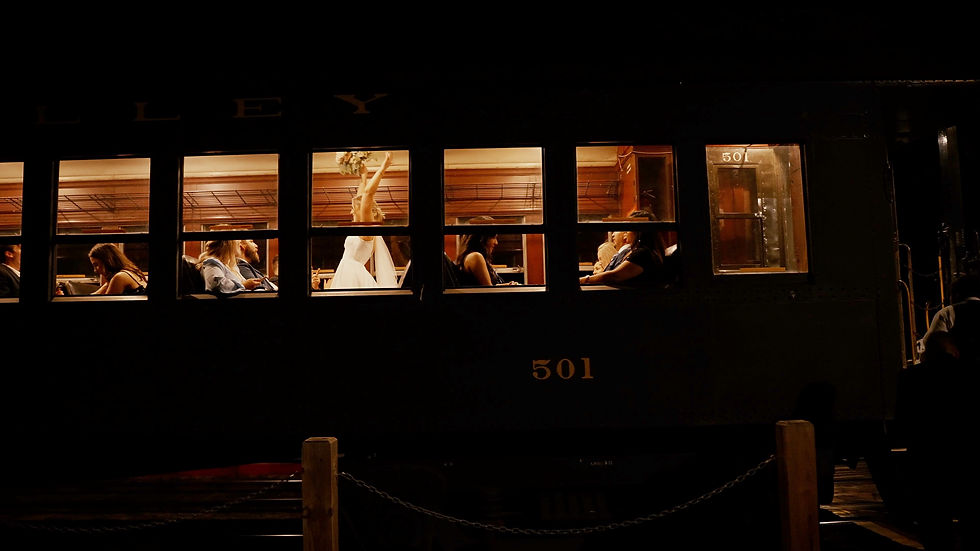 bride celebrates as she board the train to leave her wedding from The Lace Factory