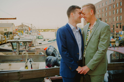 A gay couple holds hands and walks along a pier in Portland, Maine.