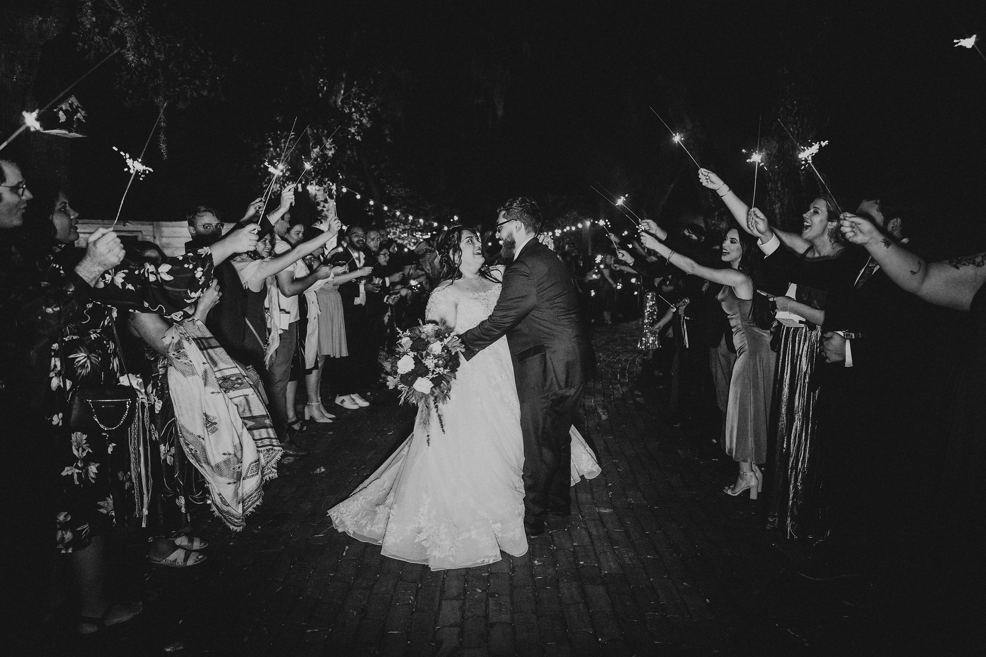 black and white photo of bride and groom sparkler exit after wedding reception