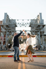 A man and woman dancing in the middle of the Mystic Bridge in Connecticut.