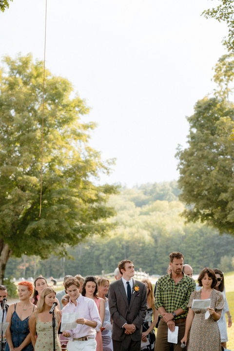 A crowd singing outdoors on a fam in New Hampshire.