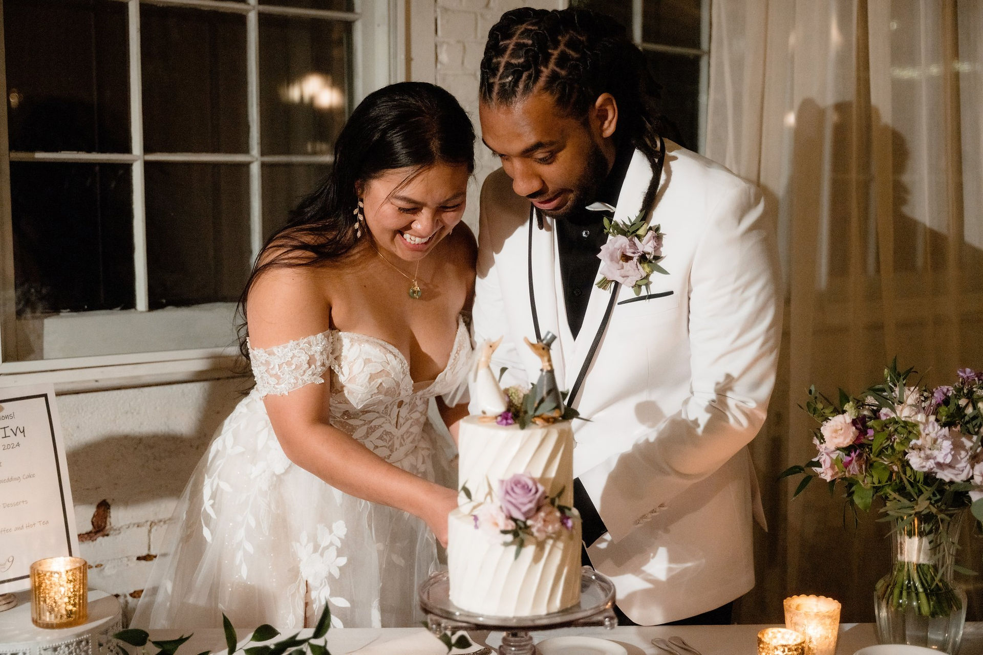 A bride and groom cutting their wedding cake at The Lace Factory in Connecticut.