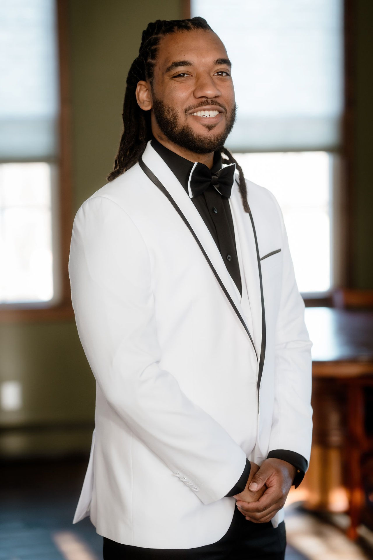 A groom posing before his wedding at The Lace Factory in Connecticut.
