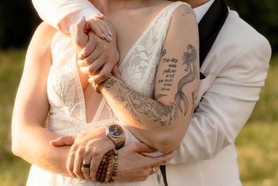 Close up of a groom wrapping his arms around his bride at sunset at Saltonstall Farm in New Hampshire.