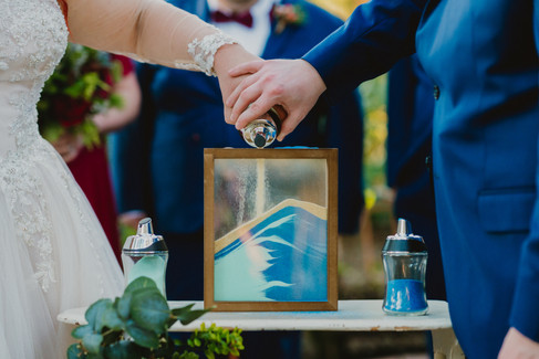 colorful blue and teal sand ceremony during outdoor wedding