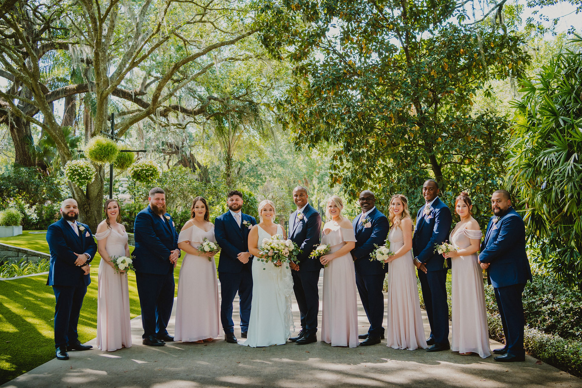 wedding party lined up outdoors and alternating between male and female