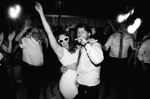 black and white photojournalistic style photograph of bride and groom on the dance floor of their wedding reception at the Wentworth Inn in New Hampshire